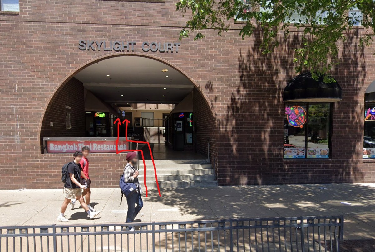 Skylight Court archway entrance at 410 E Green St with path drawn to the salon